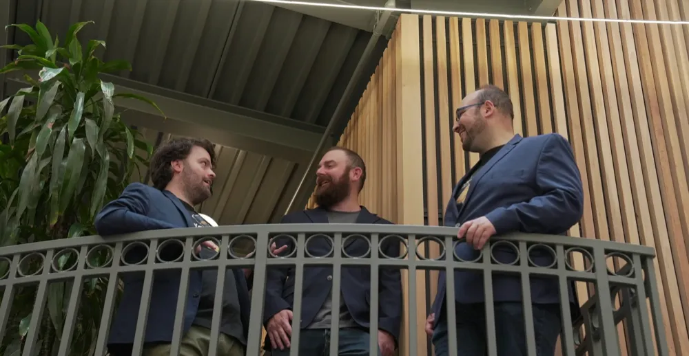 Yardrail founders talking on a balcony